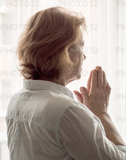 Back view woman praying