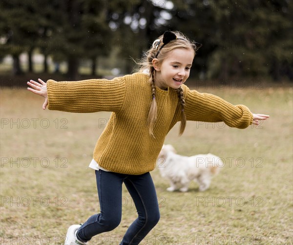 Happy girl running outdoors
