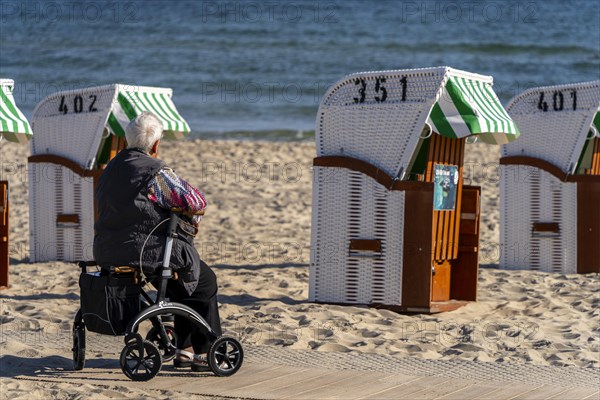 Senior citizen with rollator on the beach in the Baltic seaside resort of Baabe