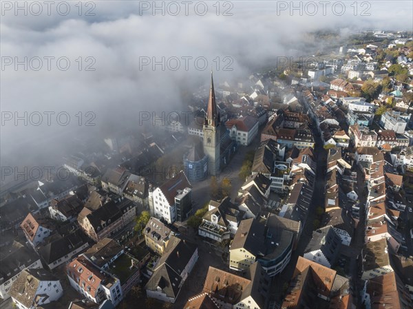 Aerial view of the town of Radolfzell on Lake Constance with autumn vegetation and drifting fog over the lake