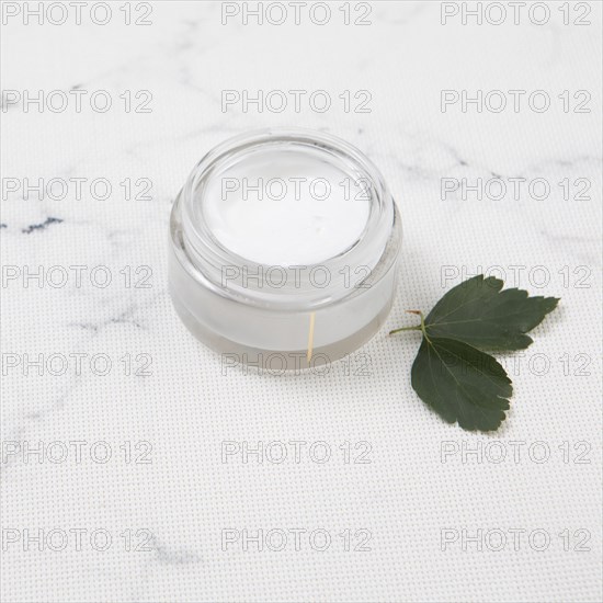 Body butter with leaves marble background