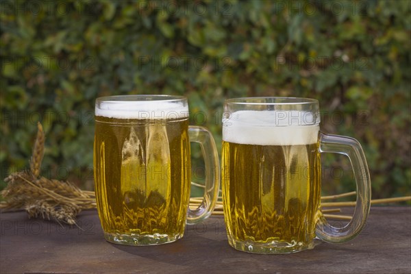 Front view two pints table with foaming beer