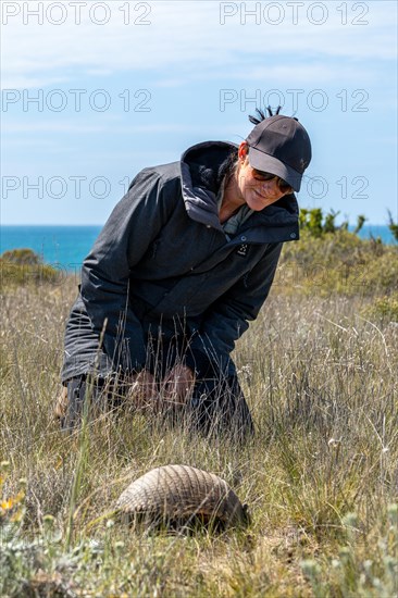 Woman and a dwarf armadillo