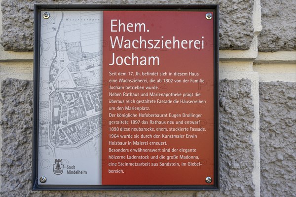 Information board about the former Jocham house with a statue of the Virgin Mary