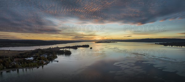 Aerial panorama of western Lake Constance in front of sunrise with the Mettnau peninsula and the island of Reichenau on the horizon