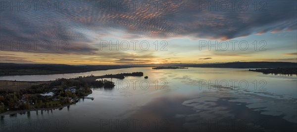 Aerial panorama of western Lake Constance in front of sunrise with the Mettnau peninsula and the island of Reichenau on the horizon