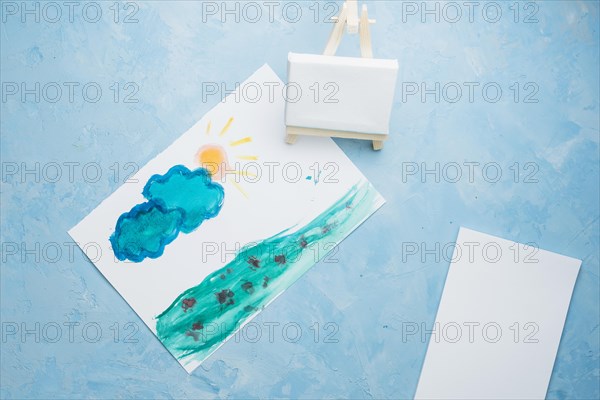 Hand drawn paper painting with mini easel watercolor backdrop
