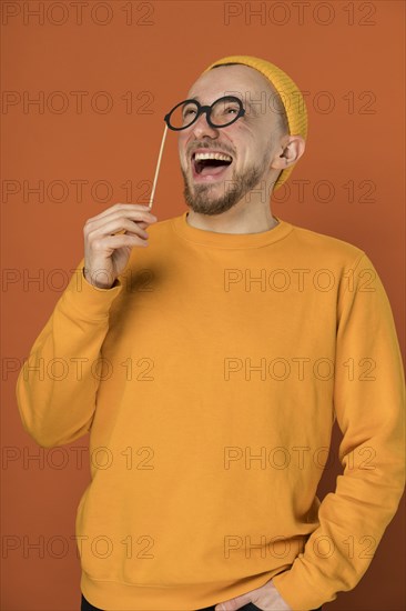 Happy young man laughing indoors 2