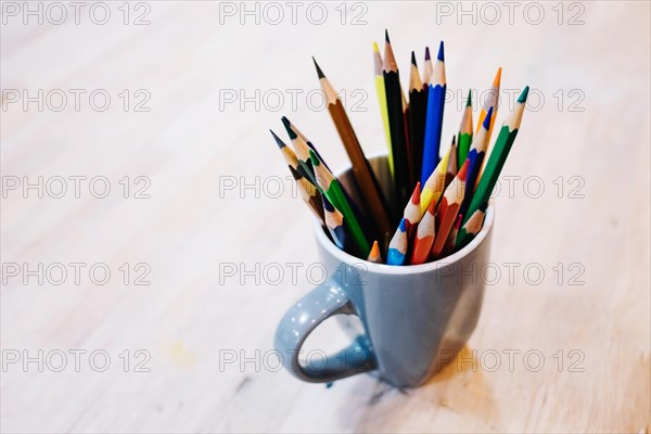Cup with colored pencils