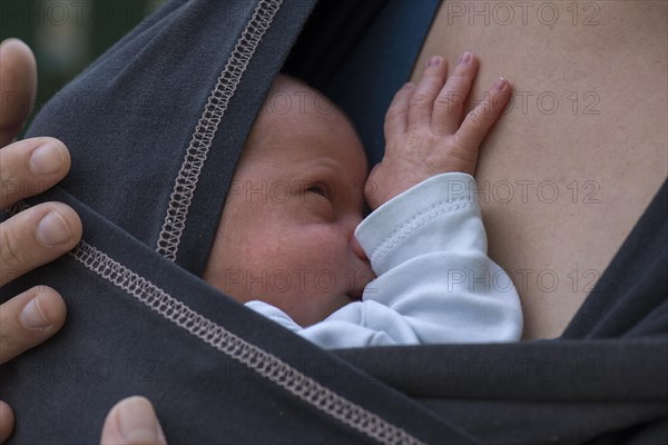 Infant in sling with mother