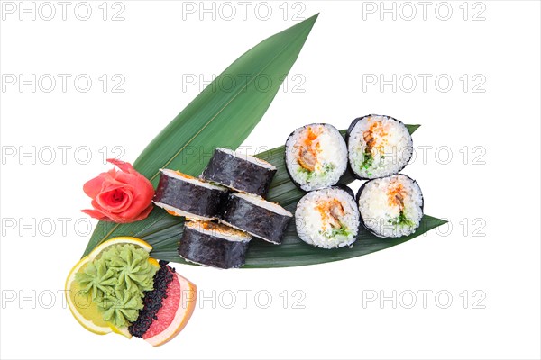 Overhead view of sushi roll with smoked eel with cucumber served on bamboo leaves