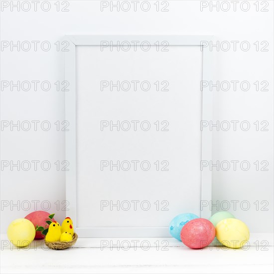 Colourful easter eggs with blank frame table