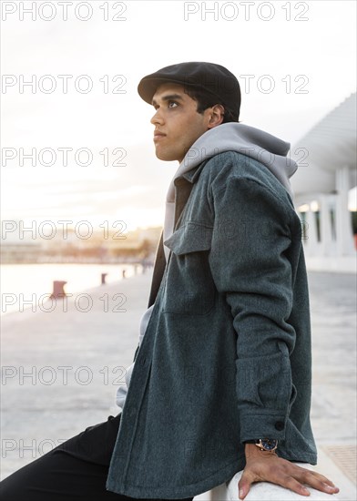 Medium shot man sitting outdoors