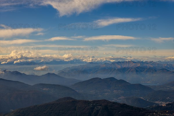 Aerial View over a Beautiful Mountainscape and And Snow Capped Mountain and with Floating Clouds in a Sunny Day in Ticino