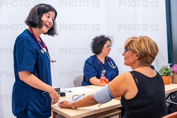 Cardiologist doctor in the cardiology clinic measuring a client's blood pressure