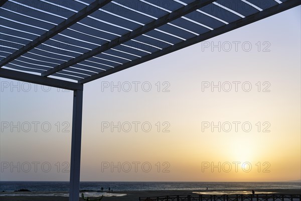 Roof of a terrace with a view of the sunset by the sea