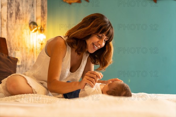 Tender scene of a baby boy and mother resting in a hotel room