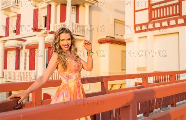 Portrait with copy space of a beauty model posing with long dress in the city during sunset
