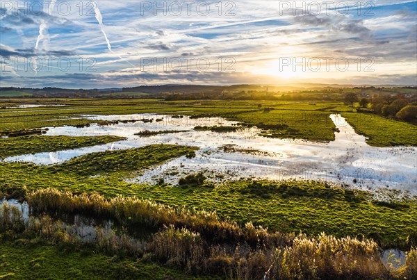 Sunset over Wetlands and Marshes in RSPB Exminster and Powderham Marshe from a drone