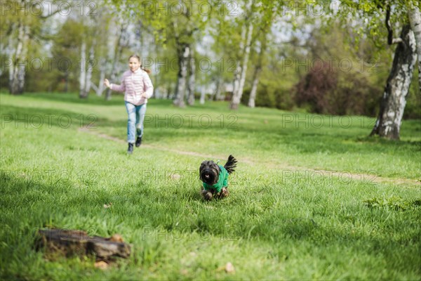 Girl running her dog