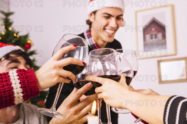Happy friends toasting christmas dinner