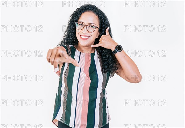 Smiling young afro woman gesturing call me and pointing at camera. Happy girl gesturing call me with fingers isolated