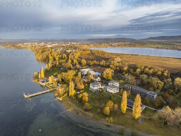 Aerial view of the Mettnau peninsula in western Lake Constance illuminated by the morning sun with the spa centre