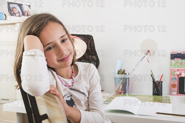 Upset girl doing homework