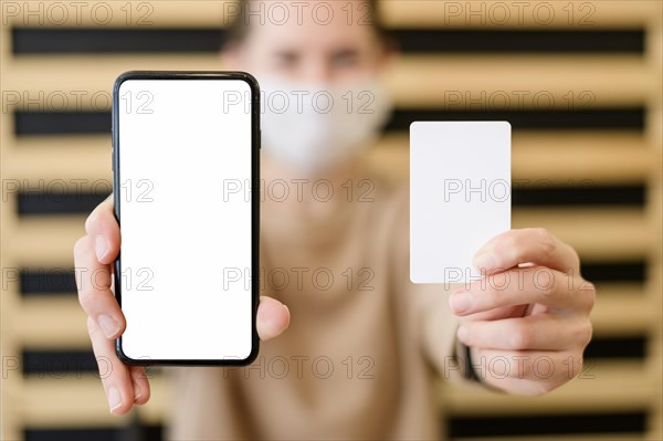 Close up woman holding mobile phone card