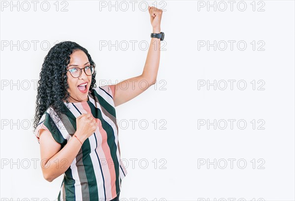 Excited afro girl raising arms celebrating victory. Happy young woman raising arms in victory gesture isolated. Winning people celebrating triumph