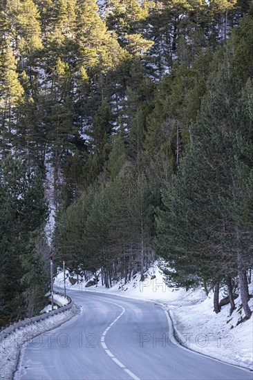 Road in the snowy mountains of the Pyrenees in Andorra during winter