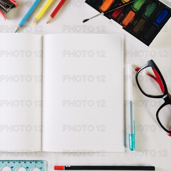Notebook with empty pages near stationery