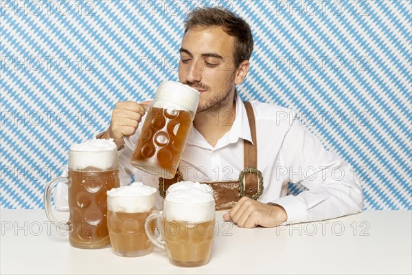 Front view man drinking blonde beer