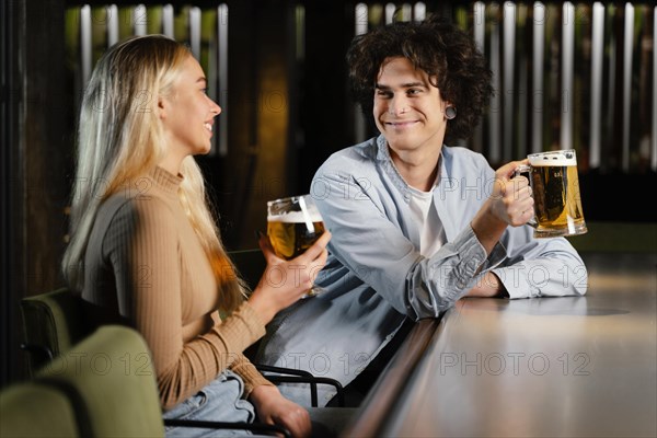 Medium shot man woman with beer mugs