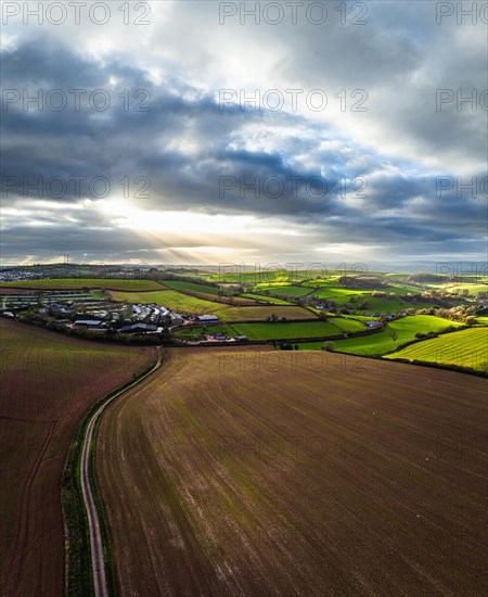 Panorama of Lights and Shadows over Fields and Farms from a drone