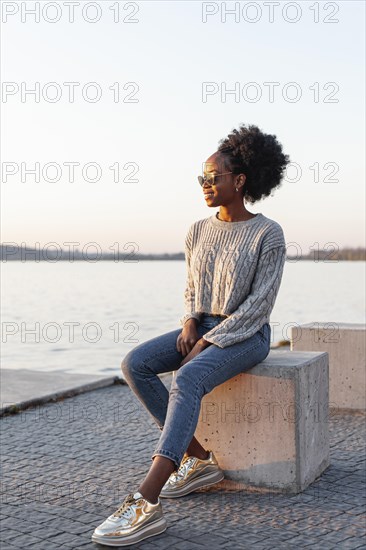 African woman wearing sunglasses looking away