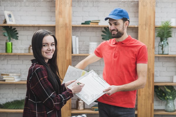 Cheerful client courier with clipboard