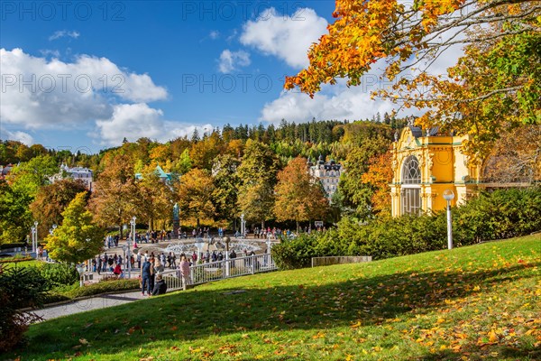 Spa colonnade with singing fountain in the autumnal spa park