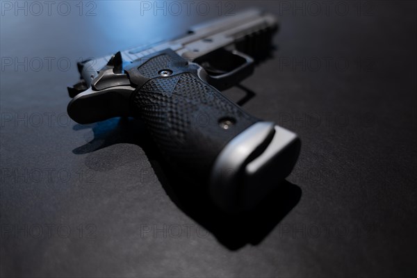 Elegant Chrome Handgun on Gray Granite Background in Switzerland