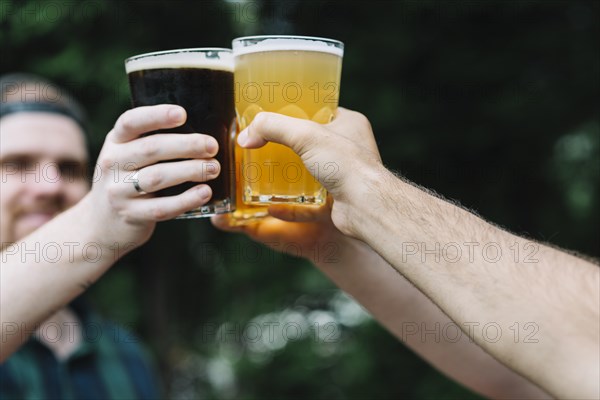 Close up friend s hand cheering glass alcoholic drinks