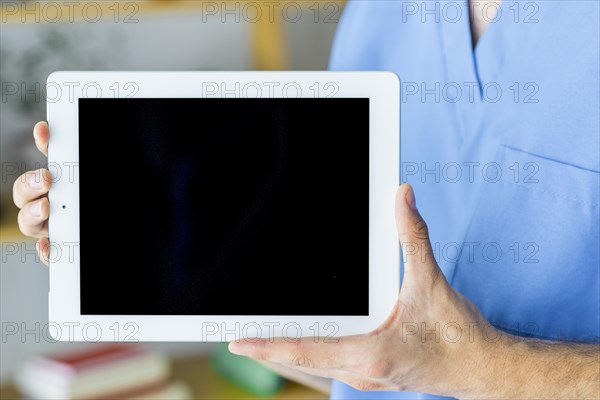 Crop surgeon showing tablet