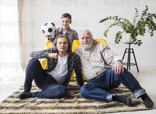 Men sitting carpet watching soccer
