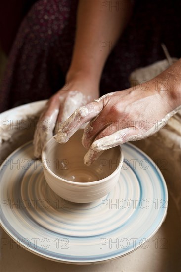 Person modeling clay potter s wheel