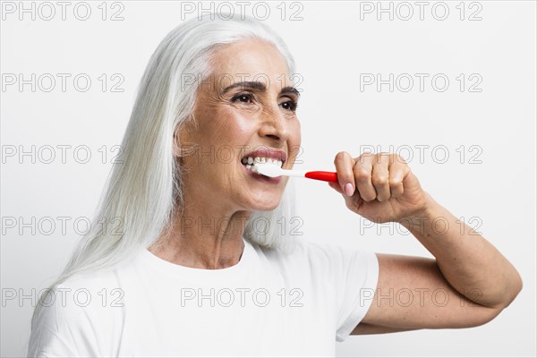Beautiful woman using toothbrush