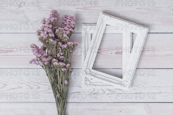 Bunch flowers near frames