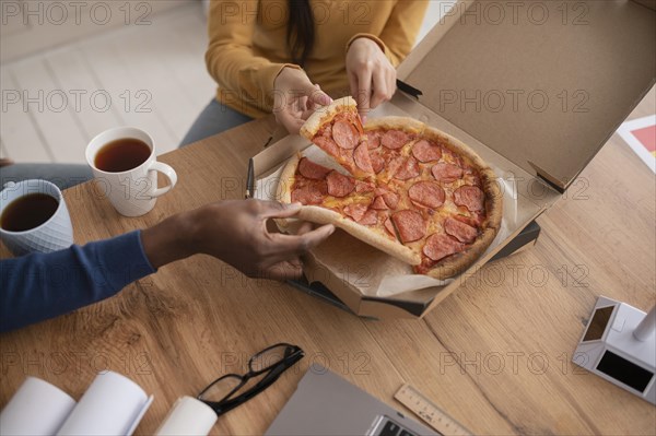 Colleagues work having lunch close up