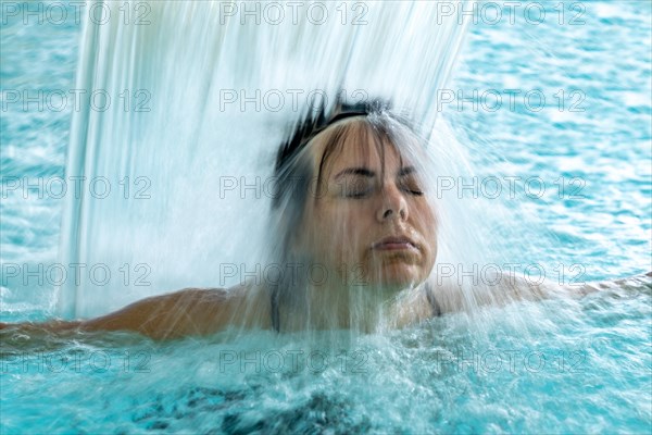 Woman Face in a Waterfall in a SPA Swimming Pool in Long Exposure in Switzerland