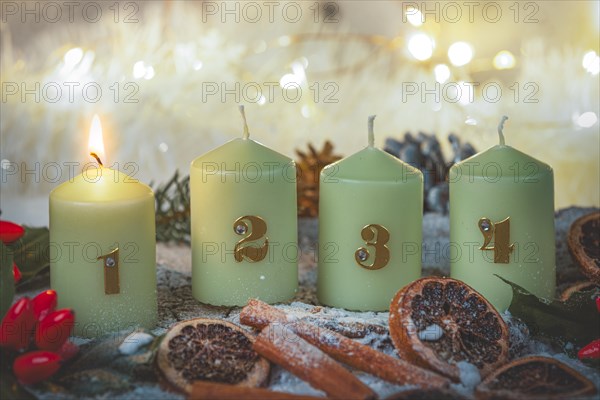 Advent candles surrounded by Christmas decorations