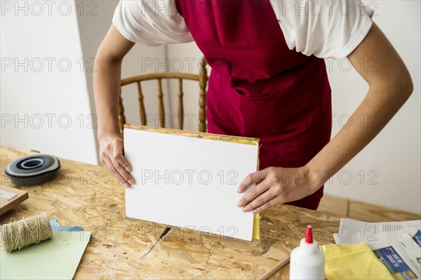 Woman s hand holding mold wooden desk