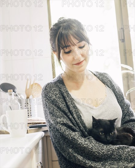 Close up woman with her kitten kitchen